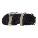 Black and beige sandal with a strap on a white background