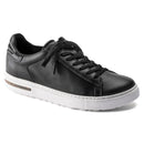 Black sneaker with white sole on a white background