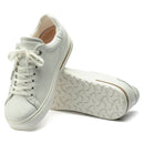 White sneakers with a brand logo on a white background