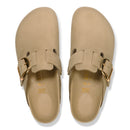 Pair of beige clogs with gold buckles on a white background