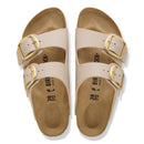 Beige sandals with gold buckles on a white background