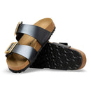 Pair of sandals with black straps and cork sole on a white background