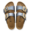 Pair of Birkenstock sandals with gold buckles on a white background