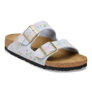 White sandals with decorative straps on a white background