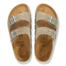 Pair of tan sandals with metallic buckles on a white background