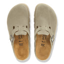 Pair of beige slip-on shoes with a white background