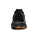 Black sneaker with brown sole on a white background