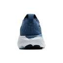 Blue athletic shoe with white sole on a white background