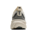 A rear three-quarter view of a sneaker on a solid white background, showing a cream-colored midsole, a gray and cream mesh upper, and a pull tab.