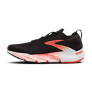 Black running shoe with orange and white sole on a white background