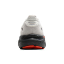 Back view of a running shoe with a white sole and red accents on a white background