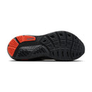 Black running shoe with red sole on a white background