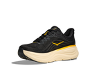Black running shoe with yellow accents on a white background