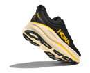 Black and yellow running shoe with 'Hoka' branding on a white background