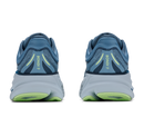 Blue running shoes with green accents on a white background