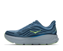 Blue running shoe with a green accent on a white background