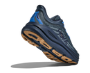 Blue running shoe with brown sole on a white background