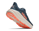 Navy running shoe with orange sole on a white background