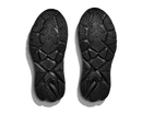 Black shoe soles with tread pattern on a white background