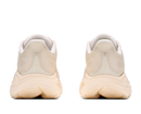 Beige running shoes with white soles on a white background
