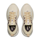 Pair of beige running shoes with visible branding on a white background