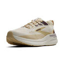 Beige running shoe with 'Brooks' branding on a white background