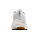 White sneaker with brown sole on a white background