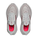 Gray running shoes with red sole on a white background