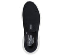 Black slip-on sneaker with white sole on a white background