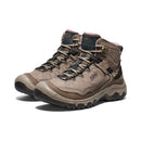 Pair of brown hiking boots with pink accents on a white background