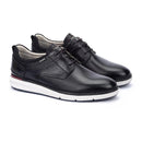 Black leather shoes with white soles on a white background
