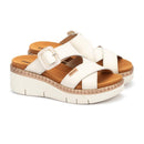 White sandals with brown soles on a white background