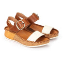Brown and white sandals with cork sole on a white background