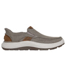 Gray slip-on shoe with brown accents on a white background