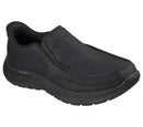 A black slip-on work shoe from Skechers, featuring a textured synthetic upper, padded collar, and a thick treaded sole, shown against a plain white background.