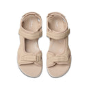 Pair of beige sandals with a bow detail on a white background