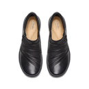 A pair of black leather slip-on shoes with diagonal stitched detailing on the toe, shown from a top-down view on a white background. The insoles show the Clarks Collection logo.