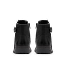 A pair of black ankle boots shown from the back, featuring side buckle straps and thick black soles, set against a plain white background.