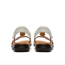 Pair of sandals with white soles and brown straps on a white background