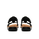 Black sandals with tan soles on a white background