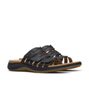 Black sandal with brown sole on a white background