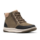 A mid-height ankle boot in olive green suede and black leather, featuring brown laces, a side zipper, and a plush beige shearling lining at the collar, set against a plain white background.