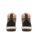 A pair of mid-height winter boots shown from the back, featuring a tan canvas upper, a black leather heel panel, a thick beige shearling lining, and a cream and brown sole.