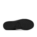 Black athletic shoe sole with red logo on a white background