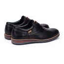 Pair of black leather shoes on a white background
