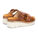 Brown platform sandals with a white sole on a white background