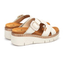 White platform sandals with brown soles on a white background