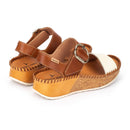 Brown wedge sandals with cork sole on a white background