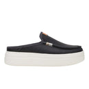 Black slip-on shoe with a white sole on a white background