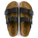 Pair of brown sandals with black straps on a white background